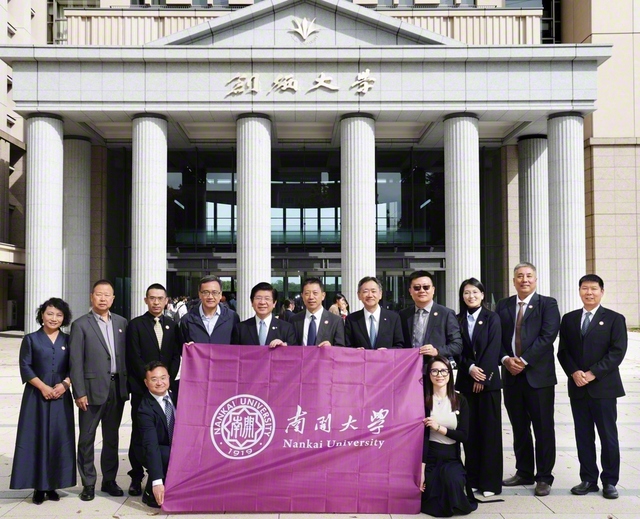 南開大学商学院の呂教授（左から7人目）一行と、創大の鈴木学長らが創大中央教育棟前で記念のカメラに