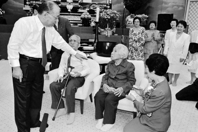 中部総会で、功労の友を壇上に招き、語りかける池田先生（1995年5月17日、中部文化会館〈当時〉で）