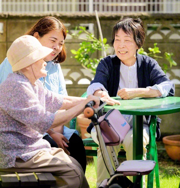 「認知症を予防するにはね……」と、地域の友と会話を弾ませる大友さん㊨。物忘れが気になる友には、安心の一言を添える、日だまりのような心地よさがある