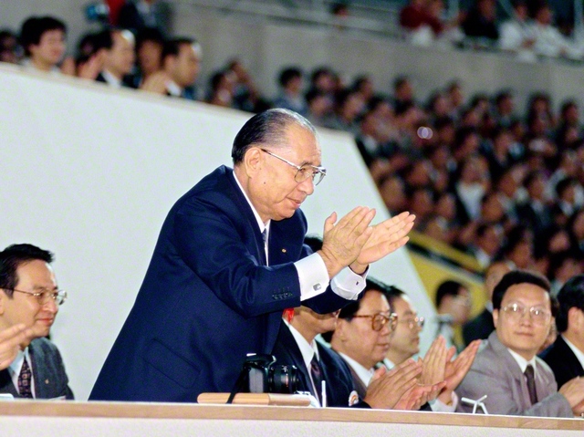 5万人の青年がベートーベンの「第九」（歓喜の歌）を歌い上げたアジア青年平和音楽祭。青年たちの熱演を見つめた池田先生は、身を乗り出して拍手を送った（1994年11月23日、福岡ドーム〈当時〉で）