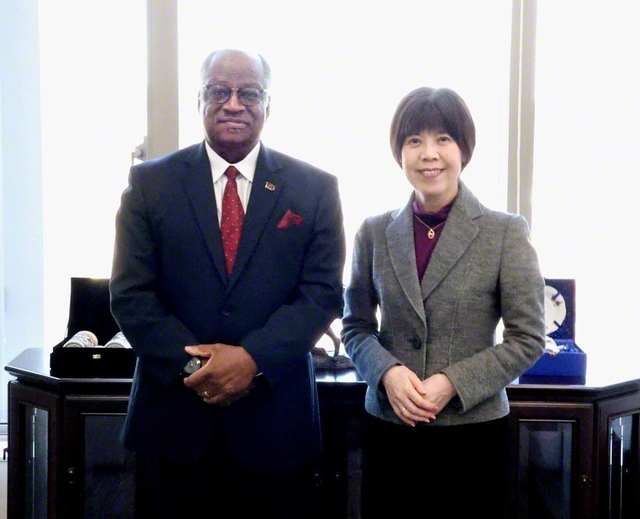 マラウイ共和国のチシザ大使㊧と創大の鈴木学長が記念のカメラに。懇談は終始和やかに行われた（創大中央教育棟で）