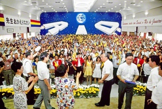 リオデジャネイロの広布32周年を慶祝する総会で、友をたたえる池田先生（1993年2月、リオデジャネイロ文化会館で）。「皆さまはブラジルの太陽である。社会の太陽である」と