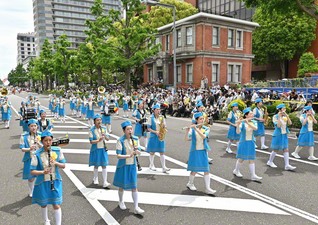 神奈川文化会館前を行進する富士鼓笛隊の創価シャイニングスピリッツと創価エアレンデル（3日、横浜市内で）