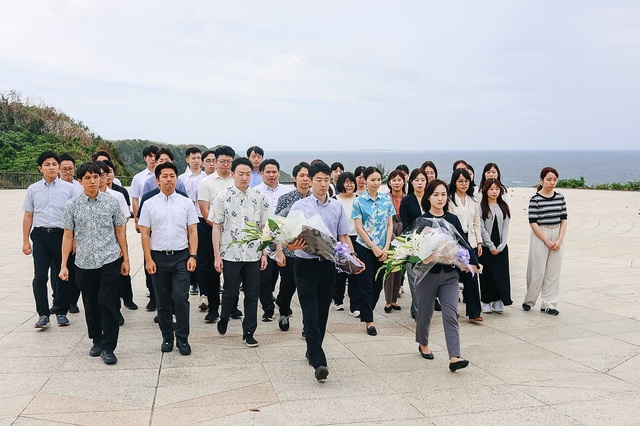 糸満市の平和祈念公園内にある「平和の礎」で、戦争犠牲者に献花する参加者（13日）