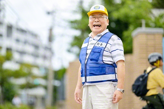 防犯パトロールのユニホームを着て、底抜けに明るく笑う。「学会の中で、池田先生と共に生きてきたけん、今があるとばい」