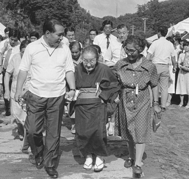 白山総ブロック（当時）の功労者と共に歩く池田先生（1976年7月25日、三重研修道場で）