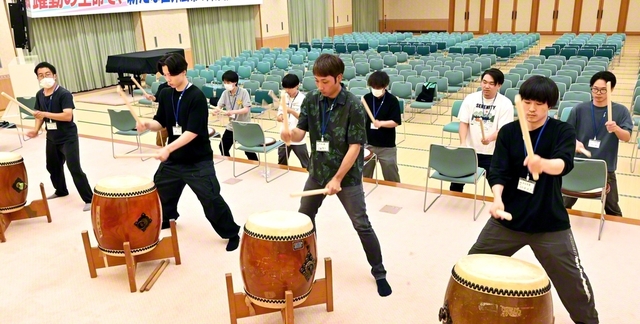 【広布の熱と力をバチに込めて　「ヤング男子部」太鼓パフォーマンス】県内各地から集まったヤング男子部の有志が太鼓練習をスタート。練習を重ねるごとに熱気も上昇中。練習の後は、皆で小説『新・人間革命』第30巻〈下〉「勝ち鬨」の章を研さん。一歩前進の挑戦を誓い合う（11日、大分平和講堂で）