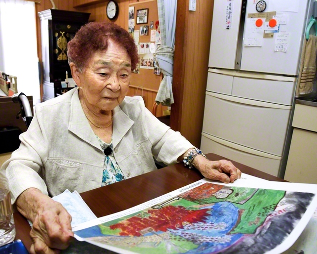 かつて自ら描いた「沖縄戦の絵」を見つめる池原さん