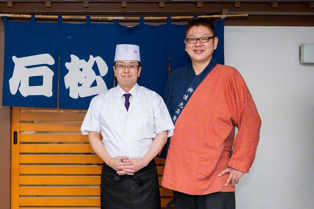 二代目店主の小島一正さん㊧と店頭で